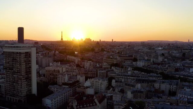 Aerial view of Paris France skyline rooftops sunset. Aerial drone panoramic view of Paris Eiffel Tower. Panoramic view of Paris at sunset. Drone video. High angle view of the Eiffel Tower and Paris. 