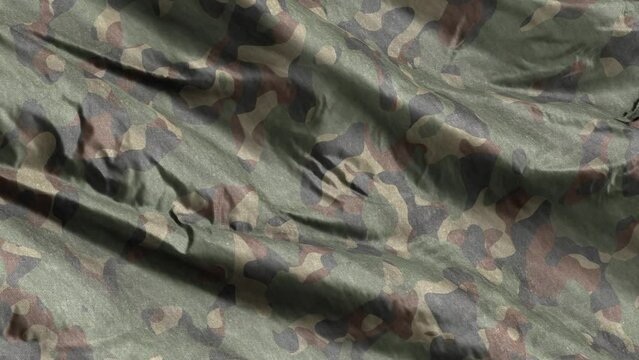 Green army camouflage textile fabric waving on the wind background. Full filling seamless loop.