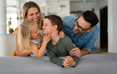 Happy family having fun time at home. Parents children love happiness concept.