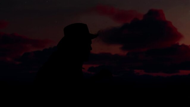 Portrait of cowboy enjoying the sunset from terrace of his house after hard day, smoking a cigar