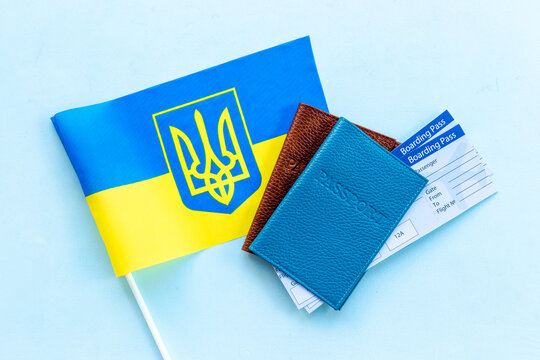 Ukrainian refugees migration concept. Ukaraine flag and passpotrs