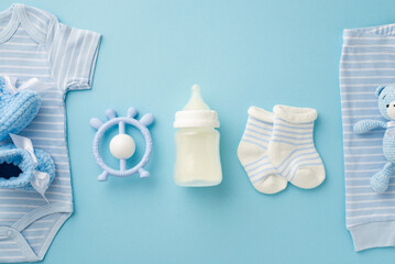 Baby accessories concept. Top view photo of blue infant clothes bodysuit panties knitted booties...