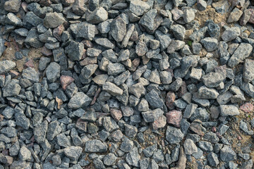 Granite gravel of macadam, rock gray crushed for construction on the ground.