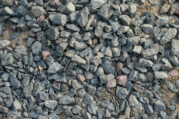 Granite gravel of macadam, rock gray crushed for construction on the ground.