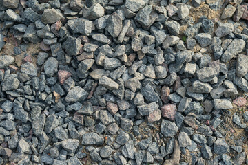 Granite gravel of macadam, rock gray crushed for construction on the ground.