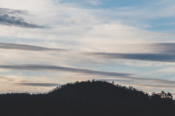 clouds formation coming and going across a winter sky over the hills of Tasmania