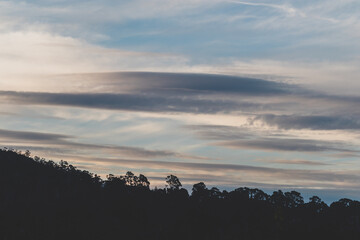 clouds formation coming and going across a winter sky over the hills of Tasmania