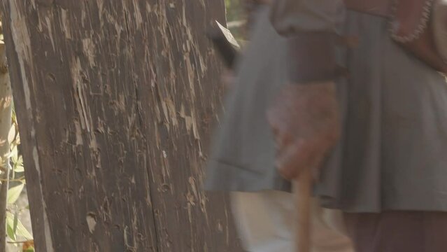 men collect hatchets after an ax shooting competition