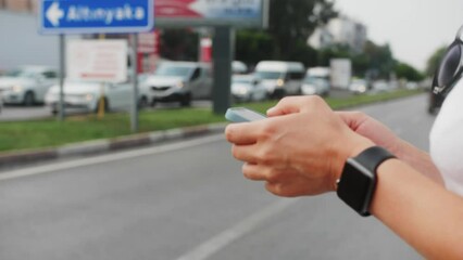 Close-up hands of woman chatting on mobile phone walk in city. Active tourist girl travel alone on street use smartphone enjoy spend time on holiday vacation. - Powered by Adobe