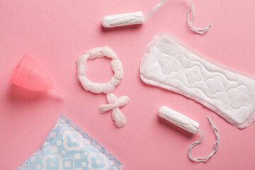 Sanitary pads, tampons, menstrual cup and venus sign on pink background, feminine hygiene products, gynecology and menstruation concept
