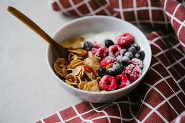 Healthy breakfast with berries, cereals and natural yogurt.