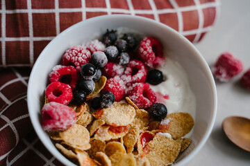 Healthy breakfast with berries, cereals and natural yogurt.