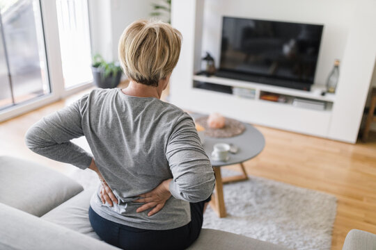 Elderly woman at home with back pain