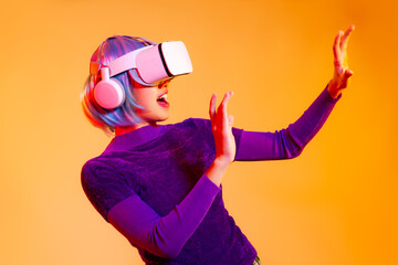 Metaverse concept, young asian woman in purple shirt cyberpunk hair style wearing vr headset...