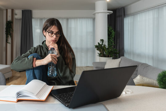 Young college student girl or freelance business woman having issue with her broken laptop. Female cant work on her old outdate computer and get frustrated and angry.