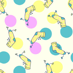 Seamless pattern with socks. Hand drawn cartoon character cute socks and dots, spots. Yellow blue pink soft colors, random chaotic pattern. Childrens drawing, design for kids