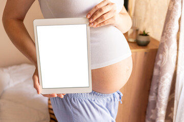 Pregnancy mockup display. Pregnant woman holding smart tablet. Mobile pregnancy online maternity application mock up. Concept maternity, pregnancy, childbirth.