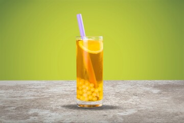 Orange Juice on a color background, in bright light. Glass of Juice with blended orange. Summer...