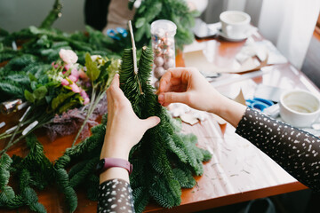 Master class on creating a Christmas tree. Close-up of hands.