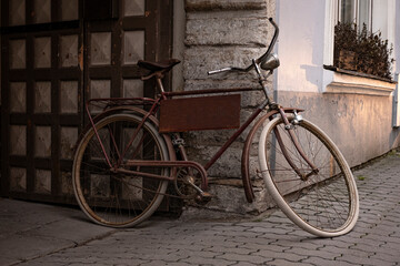 Fototapeta na wymiar Retro bicycle with house on the background. Old, cool, stylish, vintage, rusty bike. Beautiful, scenic, oldfashion, monochrome, like a movie scene. Summer vibe. Ecological, hipster transportation