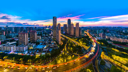 Fototapeta na wymiar Haikou Cityscape with Landmark Buildings and Urban Overpass during Evening Blue Hours, Hainan Province, the Largest Free Trade Zone in China.