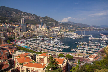 Fototapeta na wymiar Panoramic aerial view of Monaco and Port Hercule, sweeping views of the city, mountains and harbor, luxury yachts and apartments in La Condamine district, city centre Monte Carlo, Monaco,Cote d'Azur