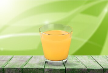 Orange Juice on a color background, in bright light. Glass of Juice with blended orange. Summer...