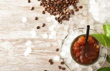Coffee drink with ice on wooden white table top view
