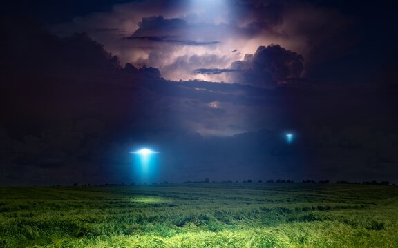 Scenic sci-fi image: UFO or alien spacecraft  inspect green grass field with bright spotlight in dark stormy night sky
