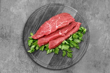Seasoned raw beef meat steak on plate.