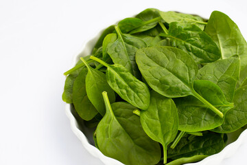 Fototapeta premium Spinach leaves on white background.