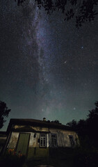 Plakat Milky Way in the background of an old and resolved house. High quality photo