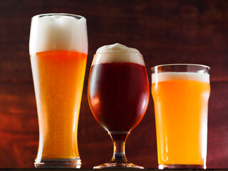 Glasses with various varieties of craft beer or draft beer in the bar . Close-up - obrazy, fototapety, plakaty