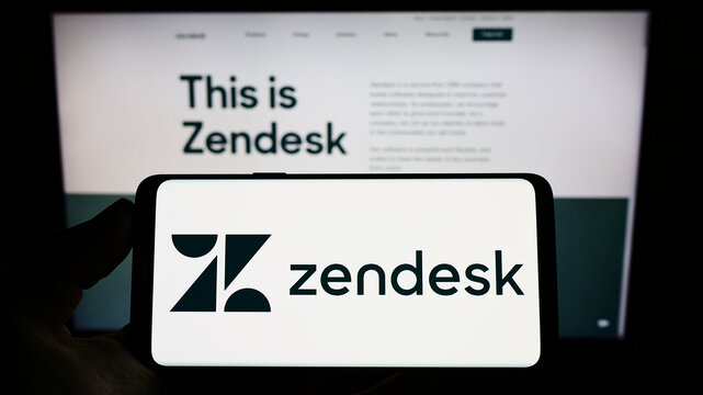 Stuttgart, Germany - 06-10-2022: Person holding smartphone with logo of US software company Zendesk Inc. on screen in front of website. Focus on phone display.