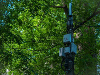 Obraz premium Concrete pole with communication boxes for internet or mobile phone.