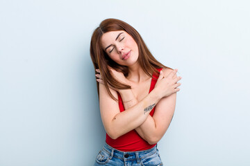 young adult pretty woman feeling in love, smiling, cuddling and hugging self, staying single, being...