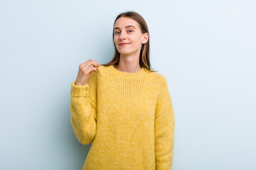 young adult pretty woman looking arrogant, successful, positive and proud, pointing to self