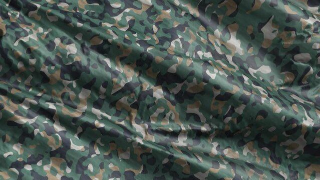 Green beige army camouflage textile fabric slow waving on the wind background. Military uniform clothing texture. Full filling slow motion seamless loop.