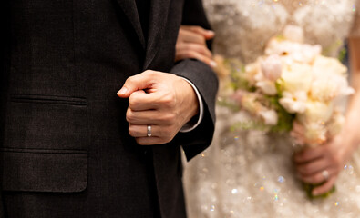 Wedding bouquet in the hands of the bride at the ceremony