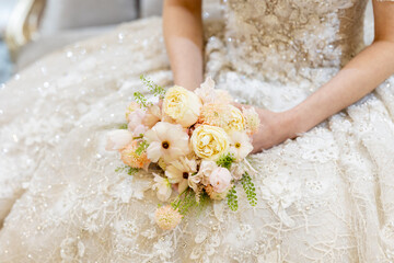Bride sitting with a bouquet in the waiting room