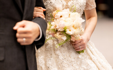 Wedding bouquet in the hands of the bride at the ceremony