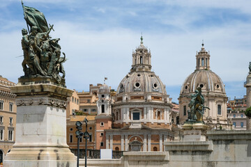 Fototapeta na wymiar Monument Vittoriano and the majestic domes of Santa Maria di Loreto and Santissima Nome di Maria at Piazza Venezia in Rome, Italy