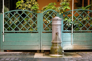 Fototapeta na wymiar Traditional drinking water fountain in Rome, Italy.