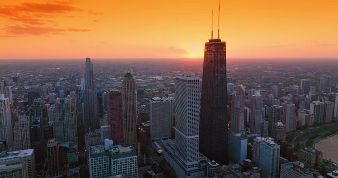 Splendid scenery of vast Chicago at setting sun. Metropolis skyline against orange skies backdrop.