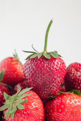 Fresh red strawberries close up on a white background.