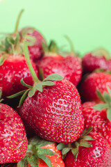 Fresh red strawberriesclose up  on a green background.