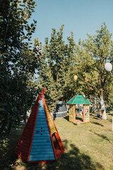Colorful kids outdoor playground equipment. A yard with children's toys. Children playground equipment. Colorful playground empty. Outdoor playground set. Play area. Play yard. 