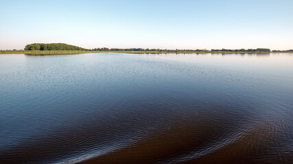 Very large water area and coast in the distance. The concept of peace and relaxation in nature.