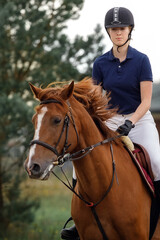 Picture in close up of young girl riding her horse.