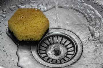 Water is pouring into the kitchen sink. Washing dishes. home plumbing